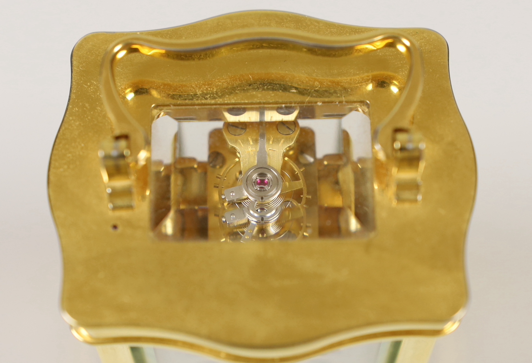 A French miniature brass cased serpentine fronted eight day carriage timepiece by L’Epee, 9cm high